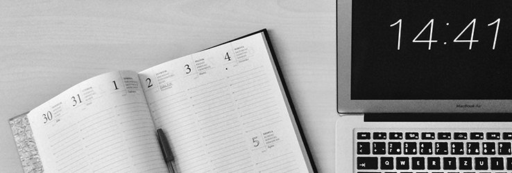 Foto van een laptop en agenda.